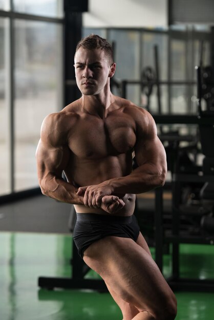 Muscular Man Bodybuilder Training in Gym and Posing Over Neutral Background  Stock Photo - Image of diet, strength: 137364968